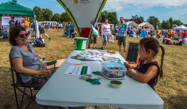 woman and child at a group publicity stall