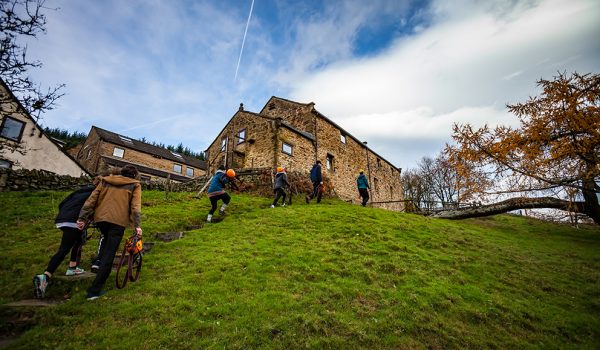 View of 6 people walking up to Lockerbook Outdoor education Centre