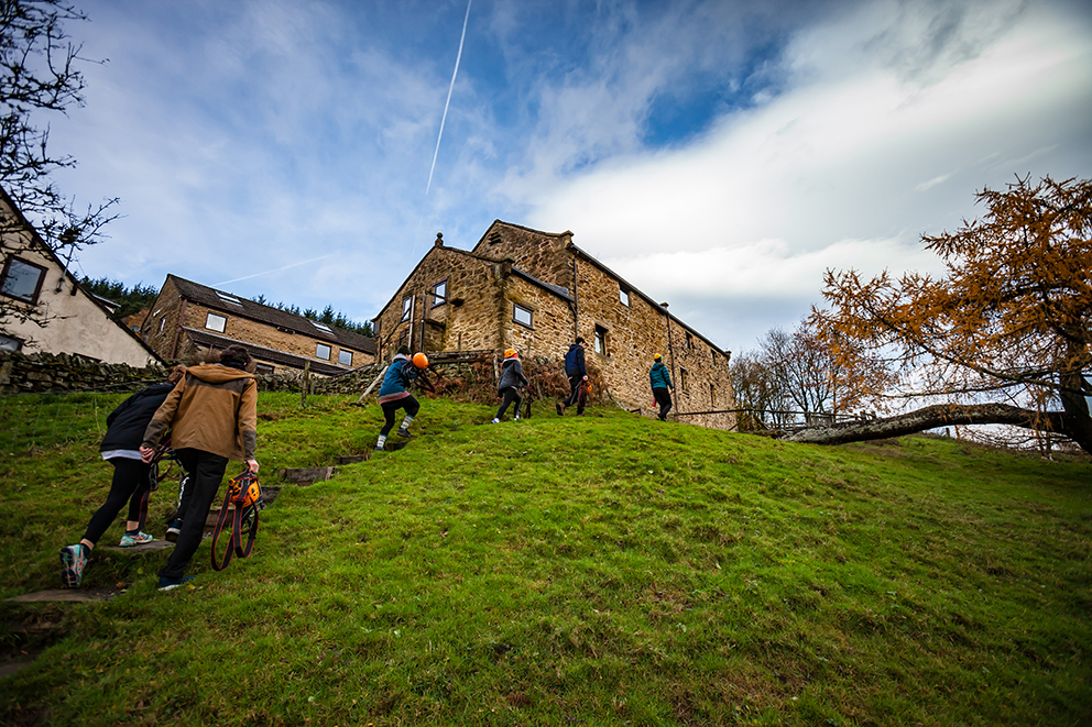 View of 6 people walking up to Lockerbook Outdoor education Centre