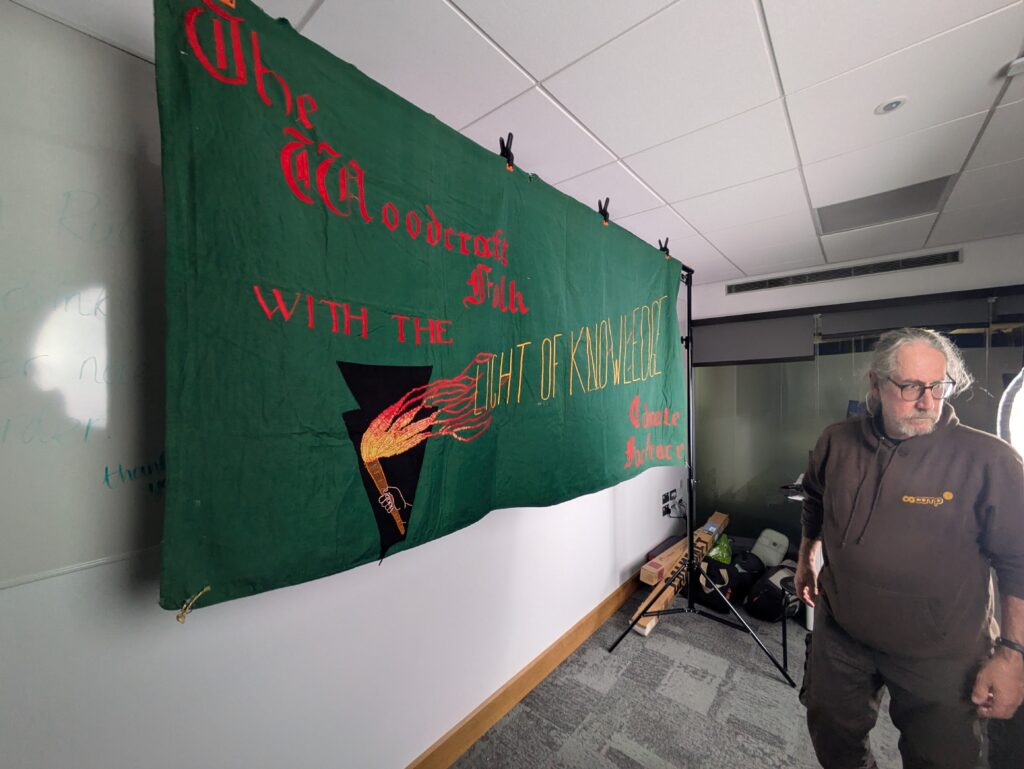 Bill with a Woodcraft banner
